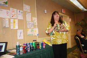 Theresa Koki with a collection of brightly colored beverage containers, some with alcohol