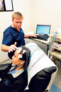 EEG tech Tery Marsh conducts an EEG to evaluate for brain damage. Nathalie Walker photos, nwalker@mideek.com