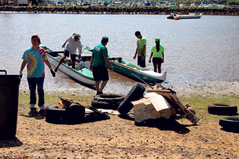 Rotary Club volunteers clean up Niumalu Beach Park for the Boys & Girls Club | Photo courtesy Justin Kollar
