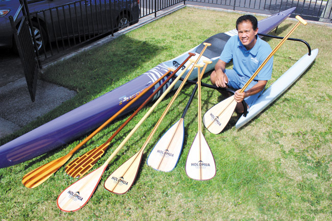 Denton Miyamura with an array of his hand-crafted Holomua paddles | Photo from Marla Miyamura