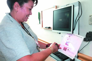 Elvenia scans the barcode of a patient to ensure they have received the proper medication