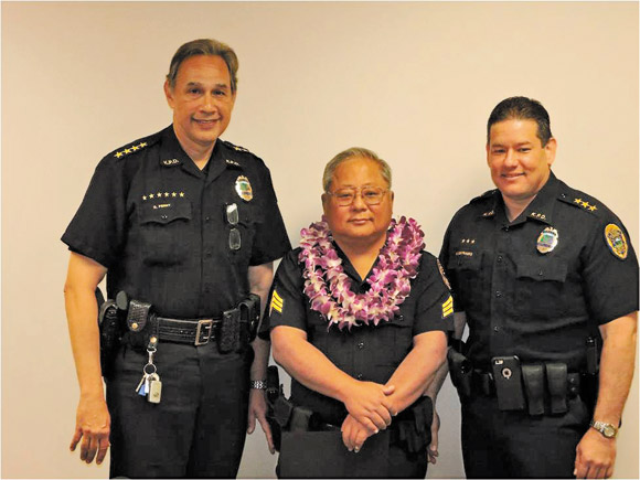 Kauai Police Chief Darryl Perry (left) and Deputy Chief Michael Contrades (right) honor Detective James Kurasaki with the officer of the month award for December | Photo courtesy Kauai Police Department