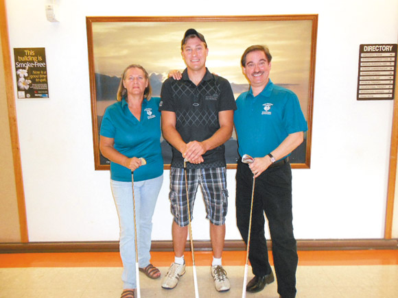 Jeremy Valck (center), who scored a hole-in-one in the Kauai Veterans Memorial Hospital tournament at Poipu, with Shelly Higgins and Steven Kline of KVMH | Photo from Steven Kline