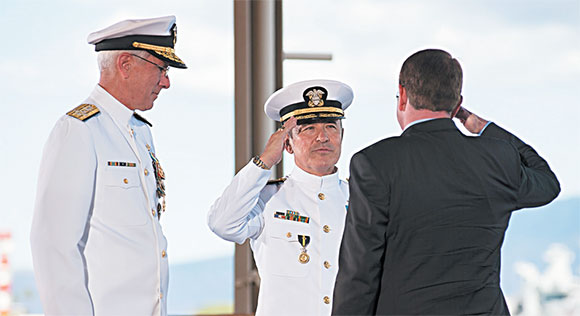 Adm. Harry B. Harris Jr. salutes Defense Secretary Ashton B. Carter as he assumes command of U.S. Pacific Command (USPACOM) during the joint USPACOM and U.S. Pacific Fleet (PACFLT) change of command ceremony at Joint Base Pearl Harbor-Hickam. During the dual ceremony, Adm. Scott H. Swift relieved Harris as the PACFLT commander, and Harris assumed command of USPACOM from Adm. Samuel J. Locklear III U.S. Navy photo by Mass Communication Specialist 2nd Class Johans Chavarro