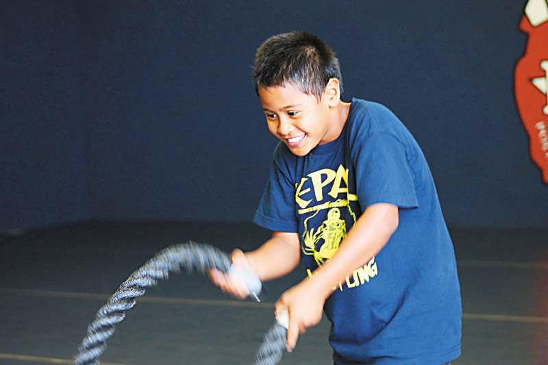 KPAL offers classes like wrestling that include several strength-training exercises, such as working heavy ropes 