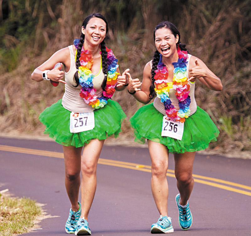 Runners don't just compete in the Kauai Marathon, they also make sure to have fun. Kristine Marayag from New York runs with Amillita Marayag from Oahu. (Coco Zickos photo) 