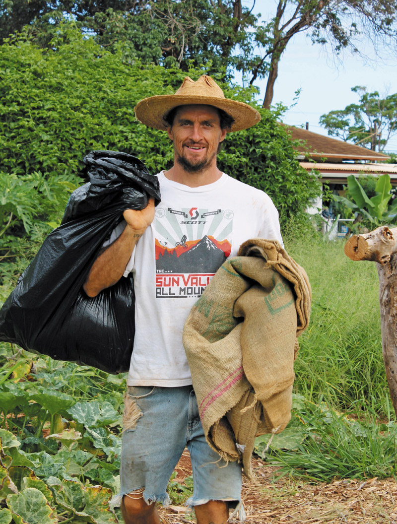 Clint Snyder busy at work at his community farm in Waimea