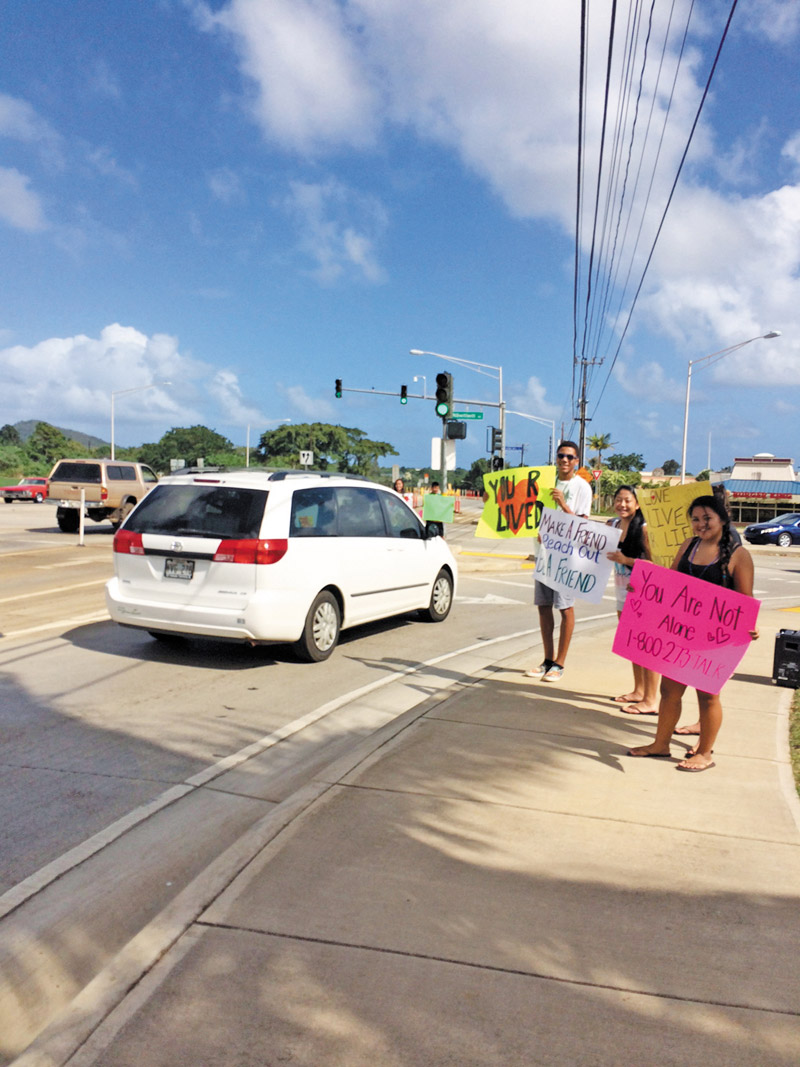 Suicide Prevention volunteers wave hopeful and helpful signs at drivers in Lihue. They plan more sign waving next month. PHOTO COURTESY PREVENT SUICIDE KAUAI TASK FORCE 