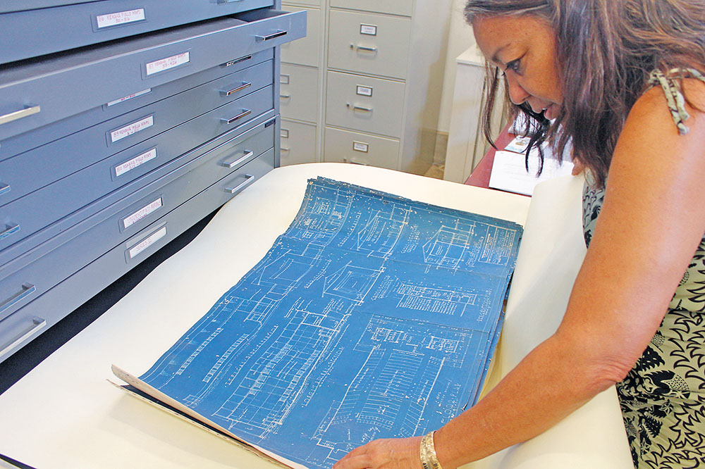Helen Wong Smith checks out one of the many maps of historical buildings stored at KHS.