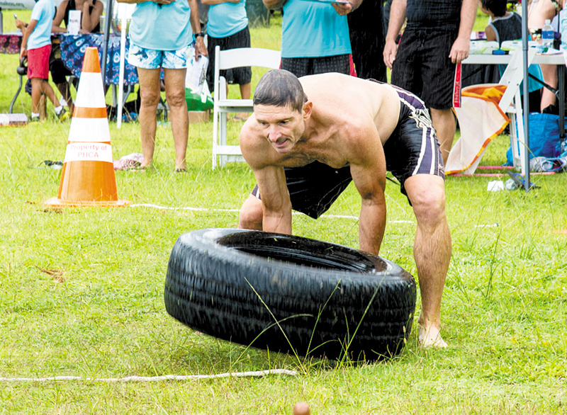 Joe Celona fl ips a tire at this year's Ohana Fit Fest