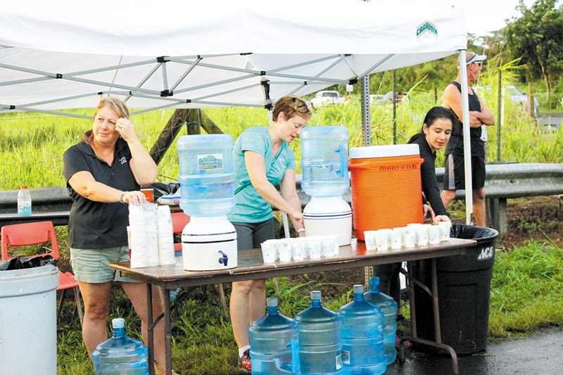 Volunteers help in many ways on race day, including distributing water