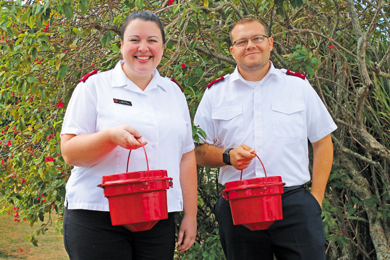 Lt. Elizabeth Gross and Lt. James Combs of The Salvation Army with the organization's signature red kettles COCO ZICKOS PHOTO