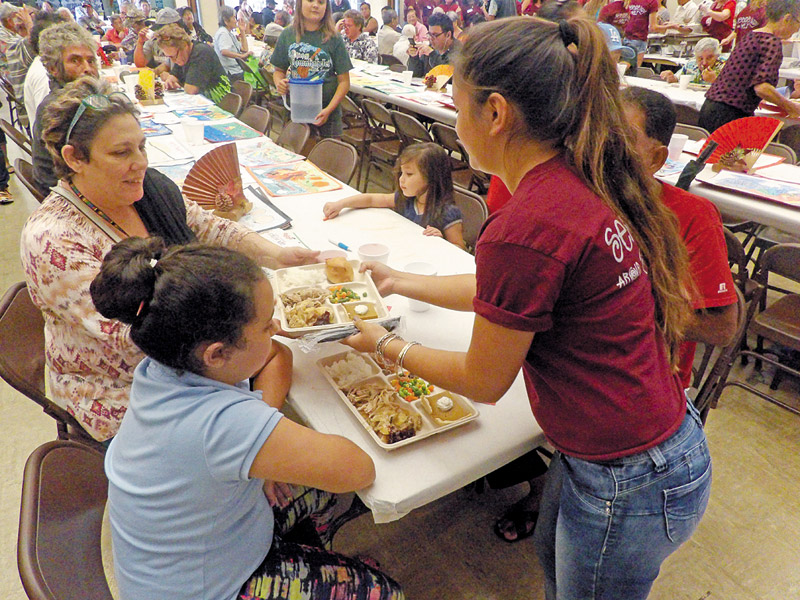 Keiki from schools around the island volunteer their time every year serving Thanksgiving meals to people in the community in Lihue 
