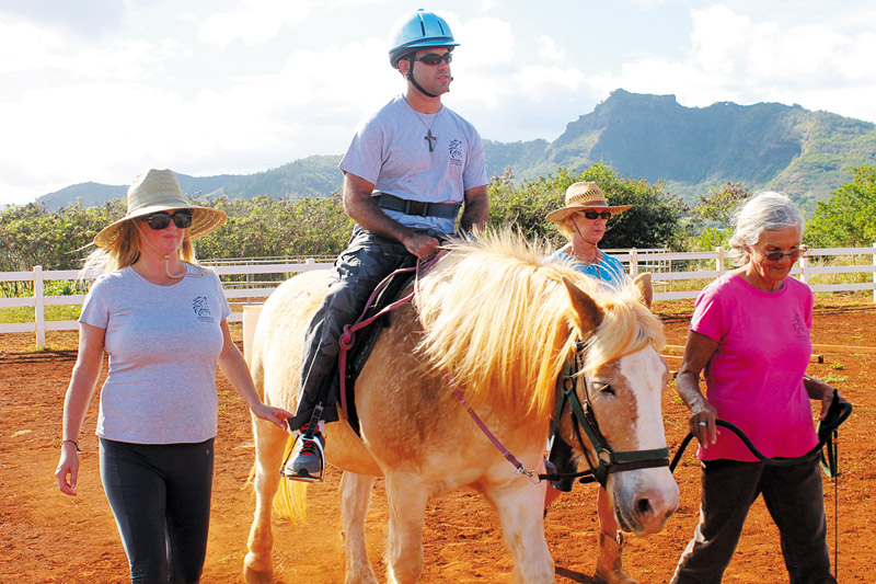 Max Gonsalves rides Ivan during a recent lesson with volunteers Melina Ward, Joann Stradley and Galann Maag