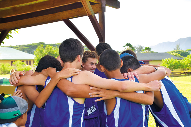 The Island School boys cross-country team huddles during a recent meet 