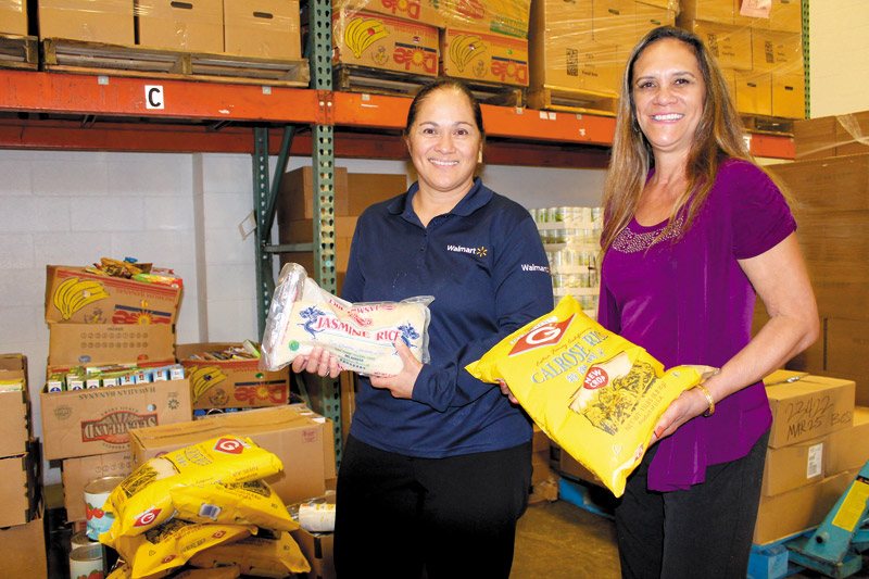 Diane Keeler of Walmart (left) and Lesah Merritt of Safeway are HFKB board members, and their employers donate more than 1,000 pounds of food to HFKB each week 