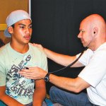 Dr. Robert Wotring examines Aaron Baltazar