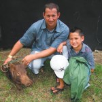 Lawai Dickens with son Pomai and pig Pork Chop