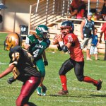 Cal Koga rolls out as Bronson Laborte (4) eyes a tackle
