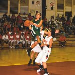 Kapa‘aâ€™s Willis Batol splits a pair of Kaua‘i defenders in the lane