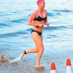 Rley Collins emerges from the swimming course.