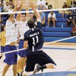 Kevin Killerman hits into the block of Logan Domingo and Canaan Higa
