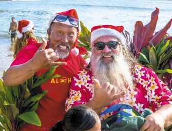 Santa Paddles Into Kalapaki Beach